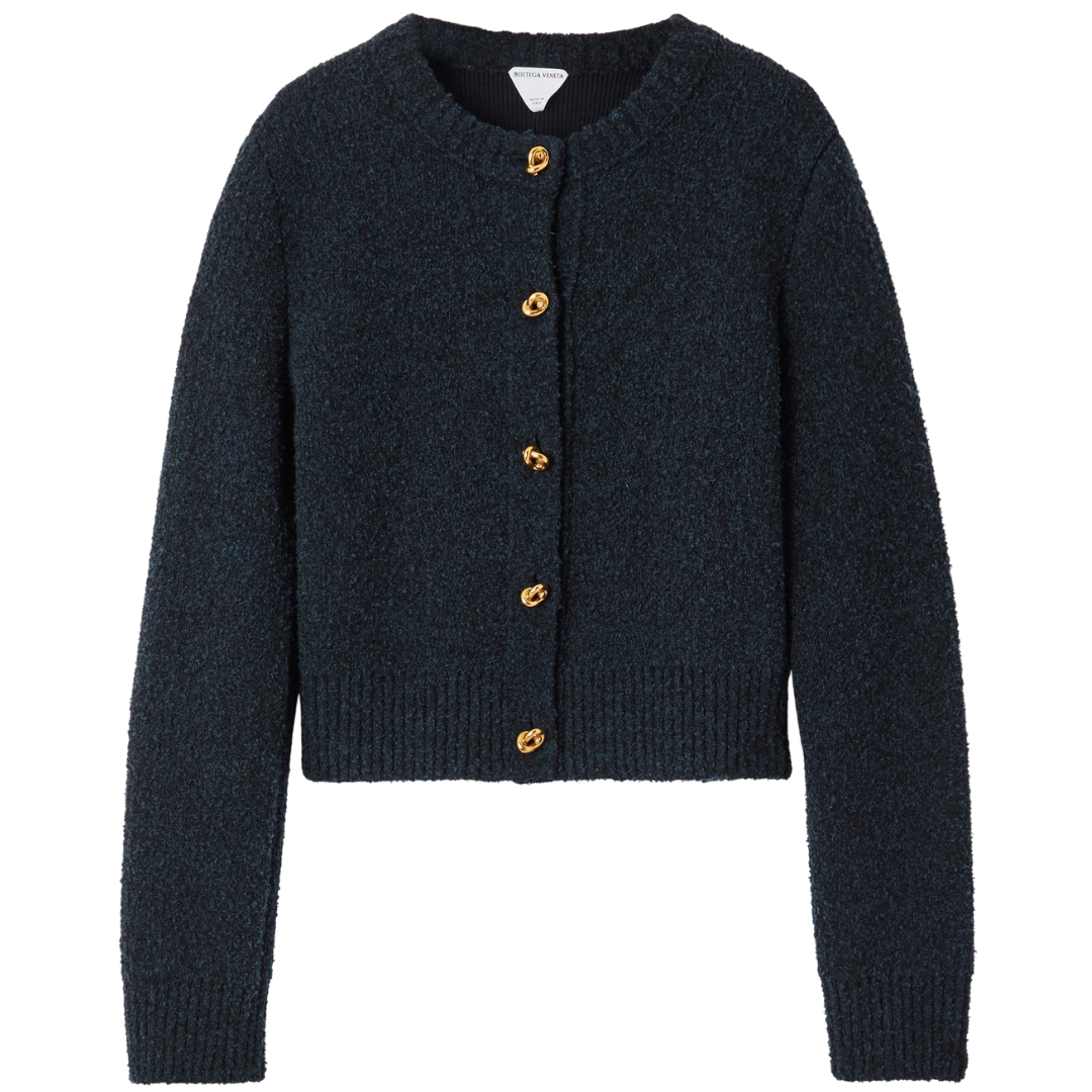 Dark blue knitted cardigan with gold buttons on a white background