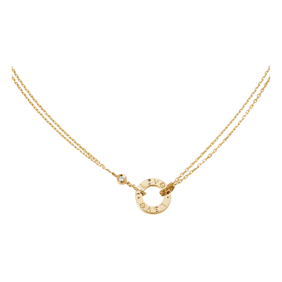 Gold necklace with a circular pendant on a white background