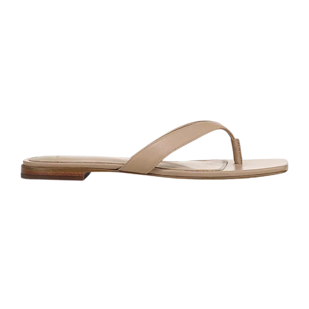 Nude colored flip flops on a white background