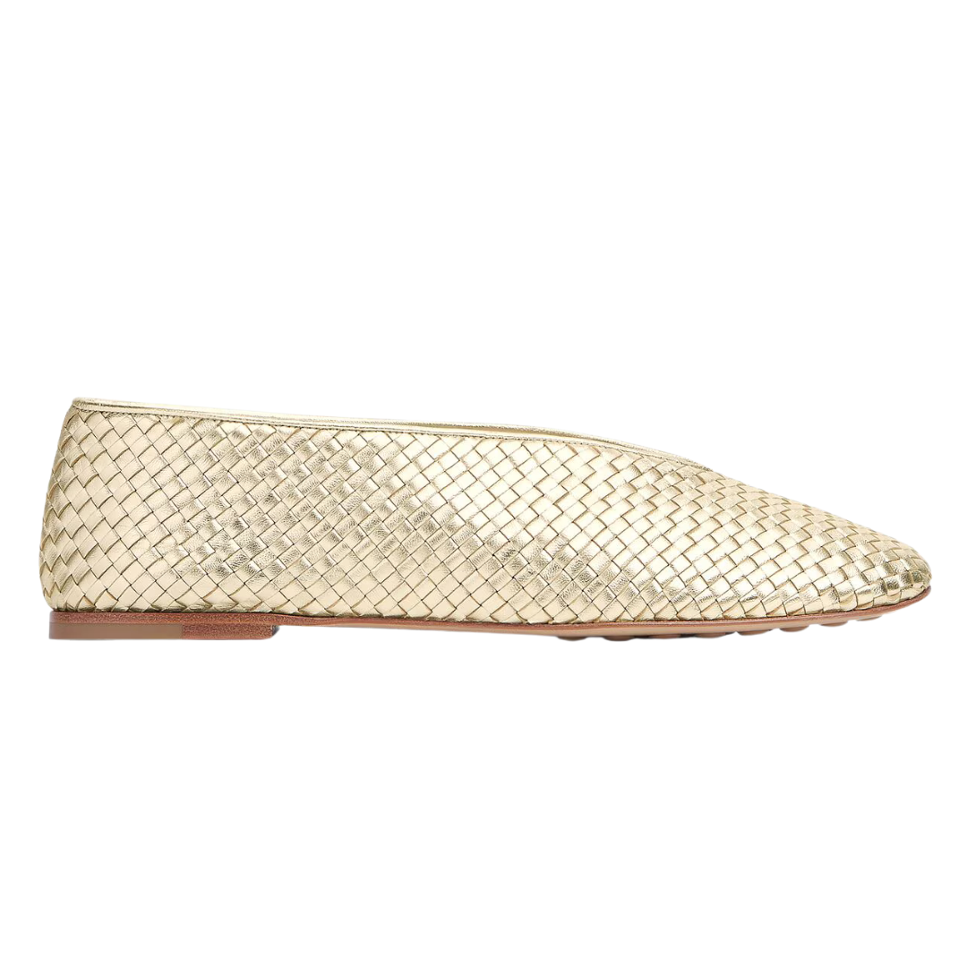 A single woven flat shoe in metallic gold, shown from a side profile view against a plain white background.