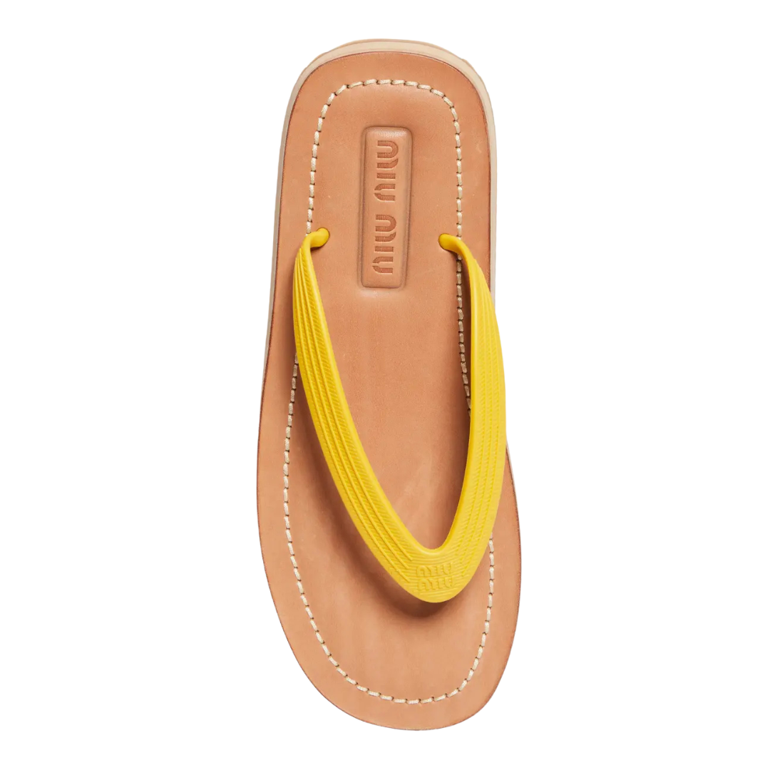Tan sandal with yellow thong on a white background