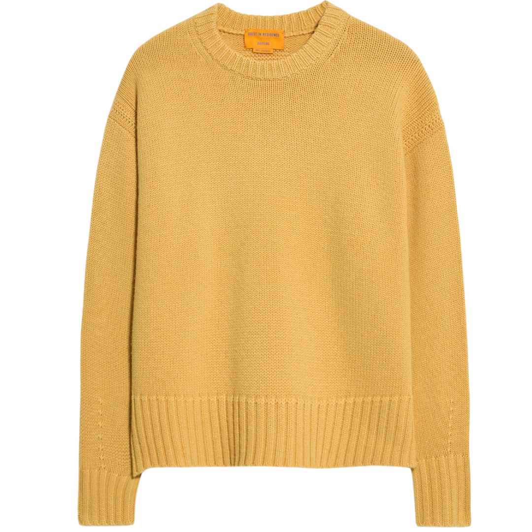 Yellow sweater with brand label on a white background