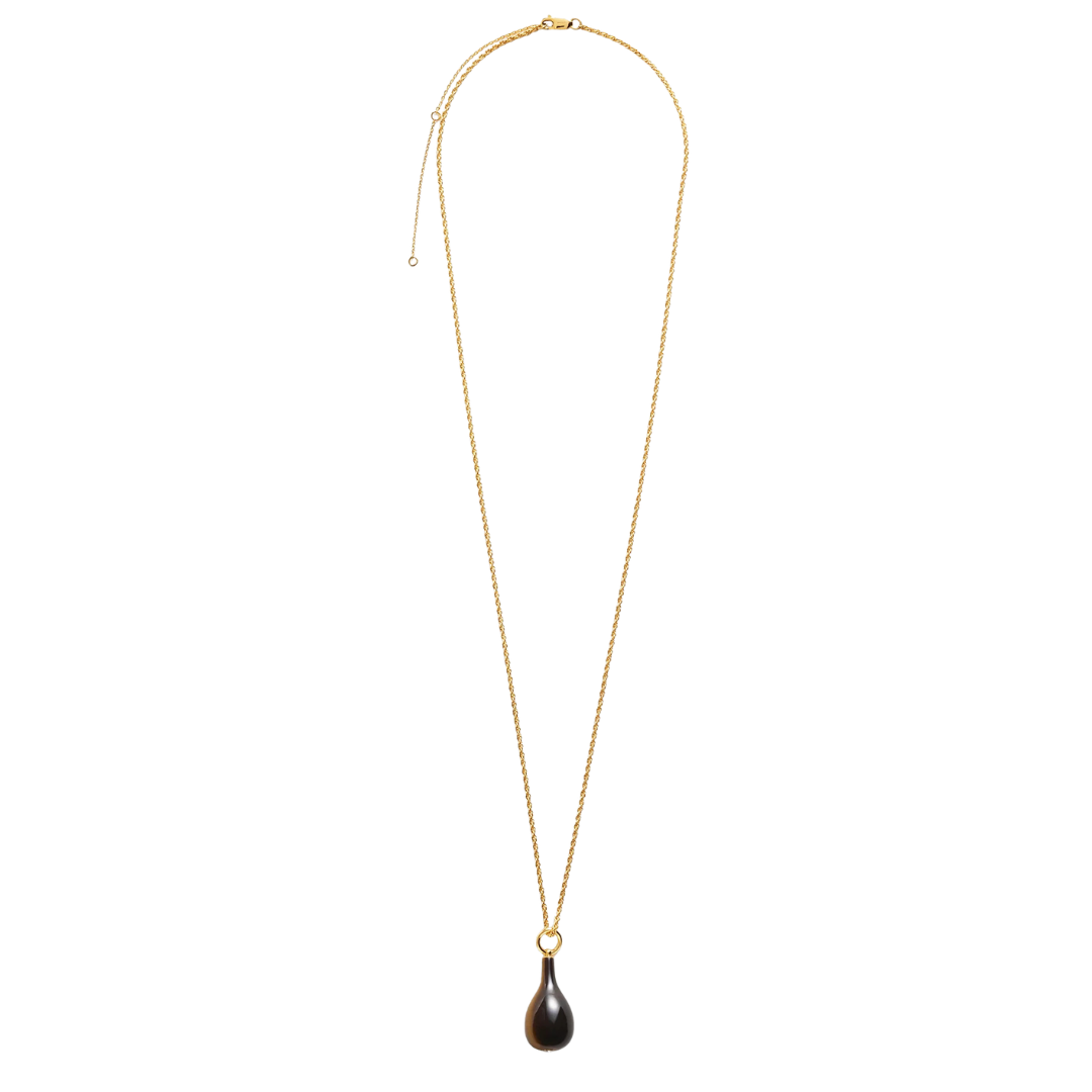 A delicate gold chain necklace featuring a small teardrop-shaped dark brown pendant, displayed against a solid white background.