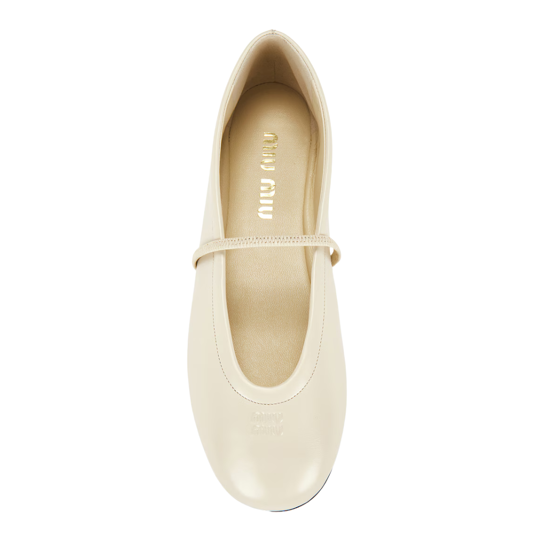 A single Miu Miu ballet flat in cream-colored leather, shown from a top-down view on a solid white background.