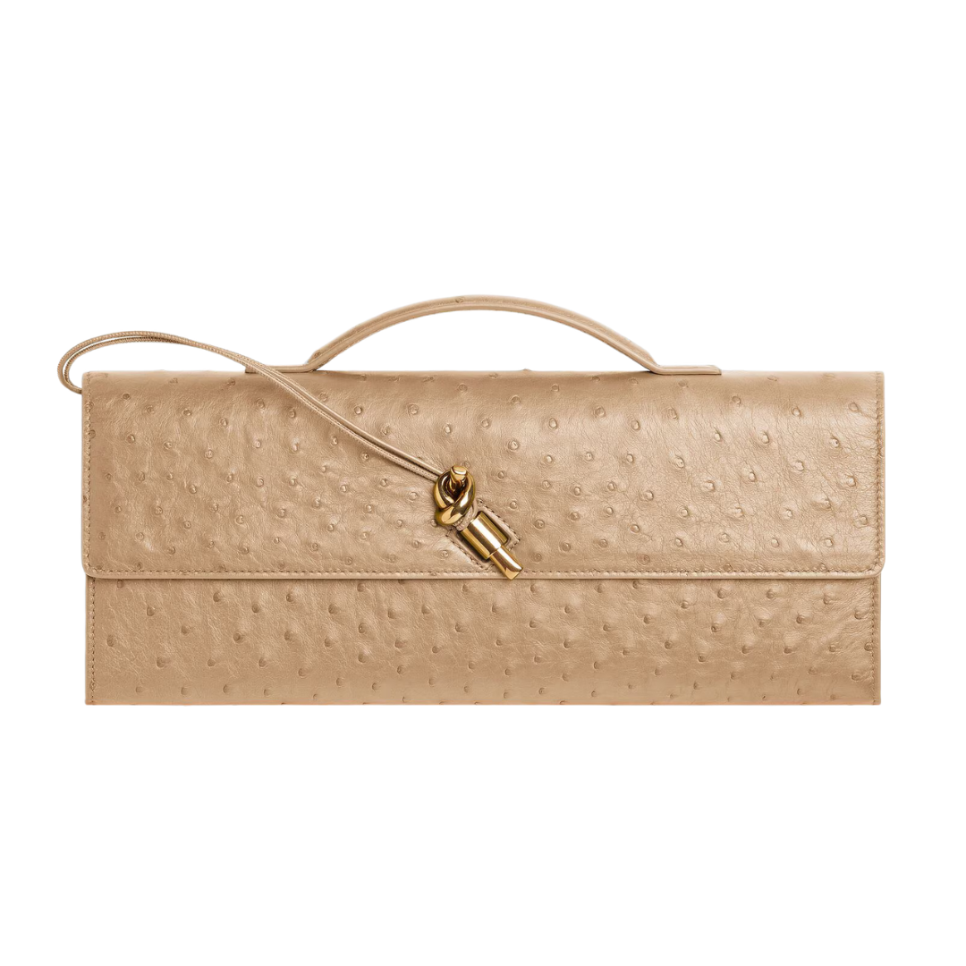 A beige ostrich leather clutch bag with a top handle and a gold-toned key ring clasp, shown against a plain white background.