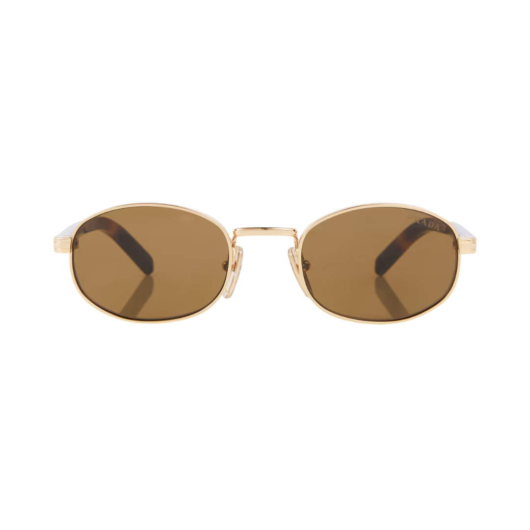 Oval sunglasses with a gold metal frame and brown tinted lenses, shown against a plain white background.